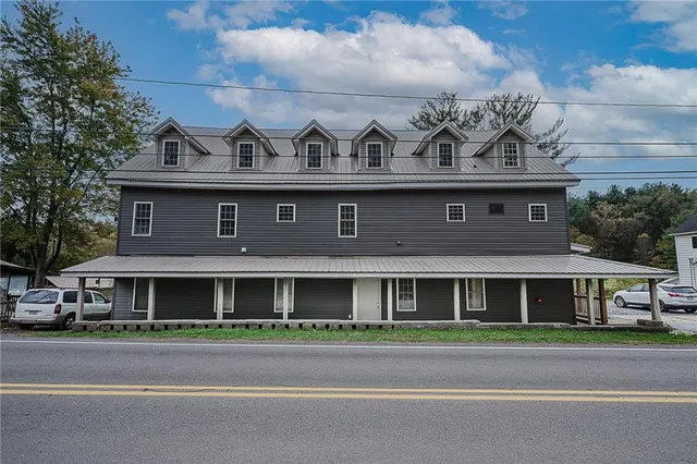 a front view of a house with a yard