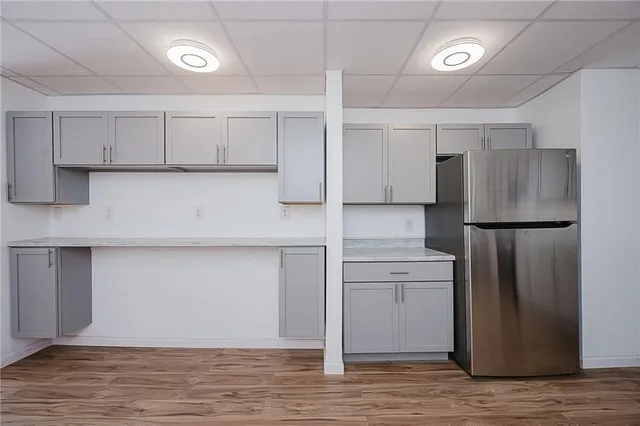 a view of empty room with wooden floor and ceiling fan