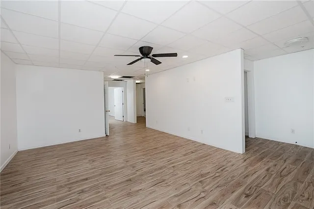 a view of a room with wooden floor and fan