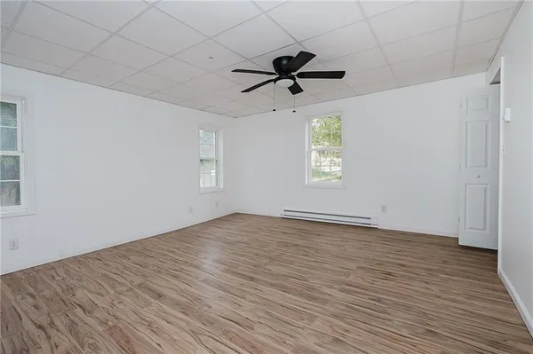a view of a room with wooden floor