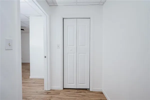 a bathroom with a sink a light fixture and a toilet