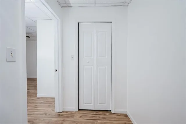 a bathroom with a sink a light fixture and a toilet