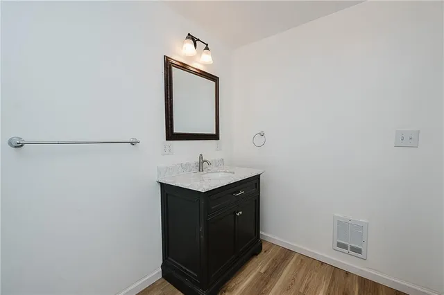 a view of a room with wooden floor and window