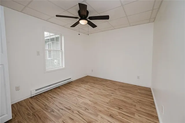 a view of a livingroom with a ceiling fan wooden floor and a ceiling fan