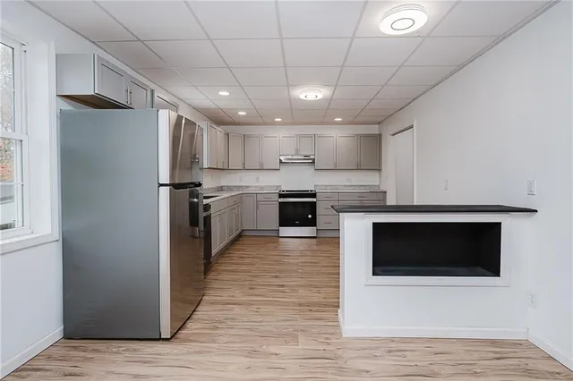 a kitchen with granite countertop white cabinets and white appliances