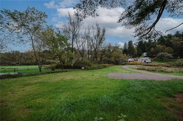 a front view of a house with a garden and yard