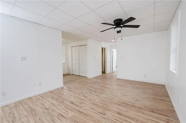 a view of empty room with wooden floor