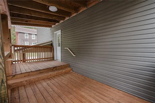 a view of a balcony with wooden floor