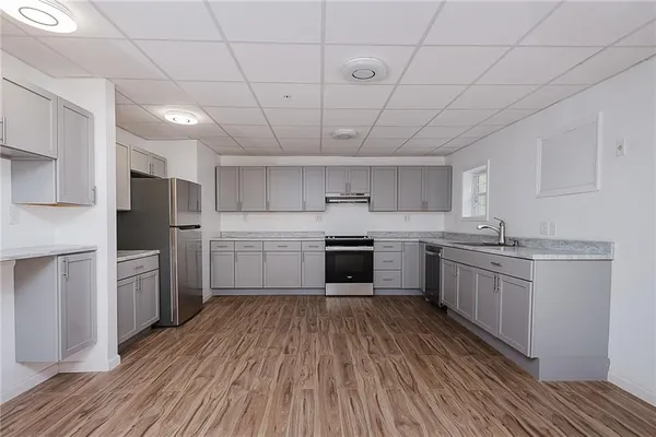 a kitchen with cabinets and stainless steel appliances