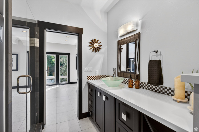 145 Carnesecca Court Mapleton, UT 84664 - Photo 17 of 109 Bathroom featuring vanity, decorative backsplash, a shower stall, and light tile patterned floors