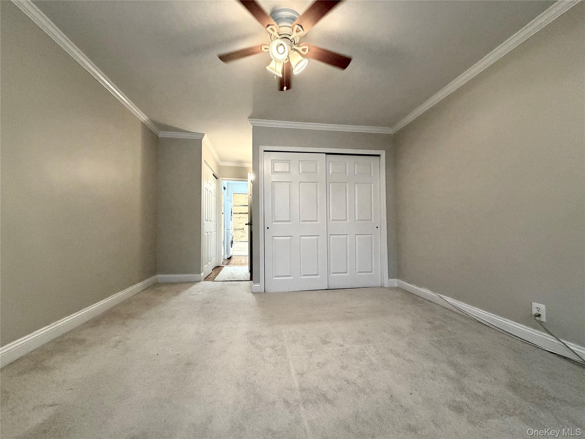 77-17 Springfield Boulevard, Unit 98 Queens, NY 11364 - Photo 11 of 18 an empty room with closet and windows