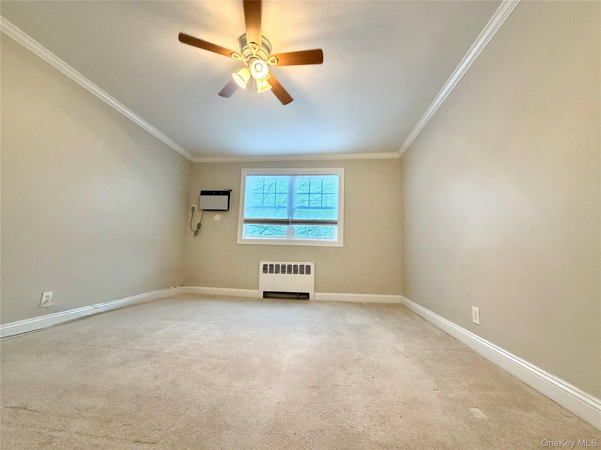 77-17 Springfield Boulevard, Unit 98 Queens, NY 11364 - Photo 12 of 18 an empty room with windows and fan