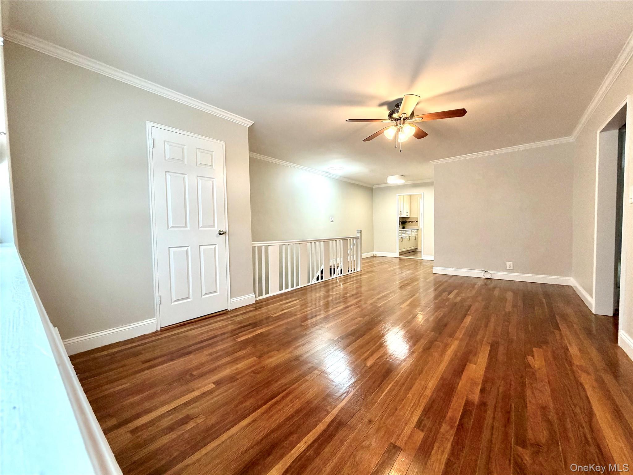 77-17 Springfield Boulevard, Unit 98 Queens, NY 11364 - Photo 13 of 18 wooden floor in an empty room with a window