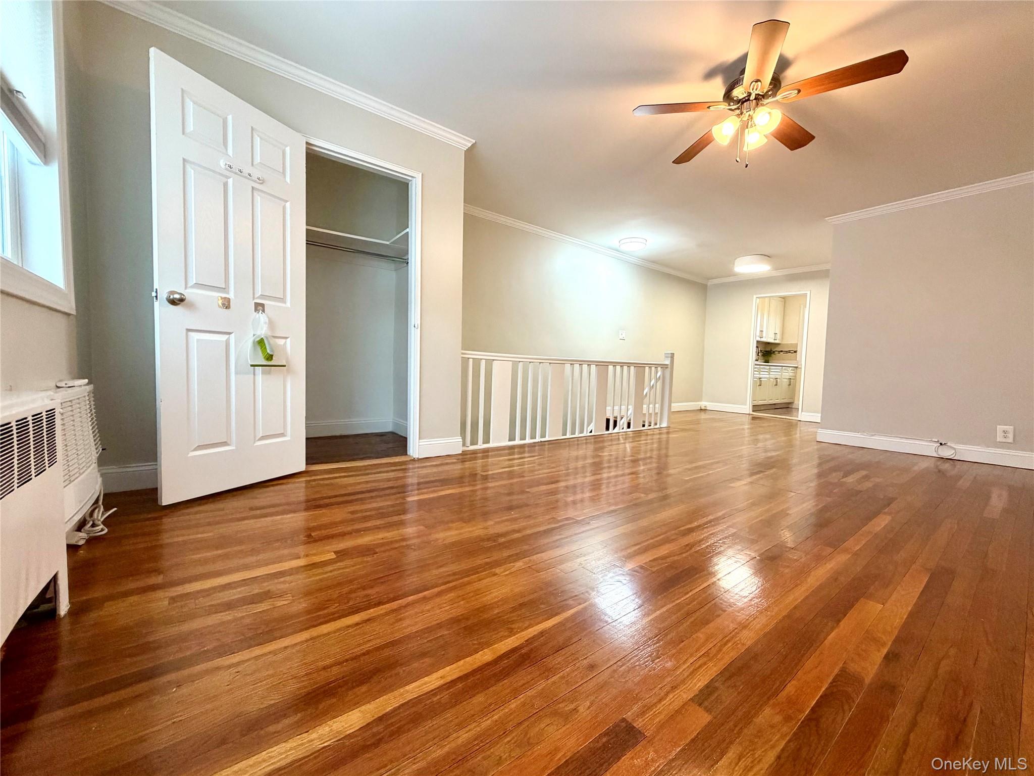 77-17 Springfield Boulevard, Unit 98 Queens, NY 11364 - Photo 14 of 18 wooden floor in an empty room with a window