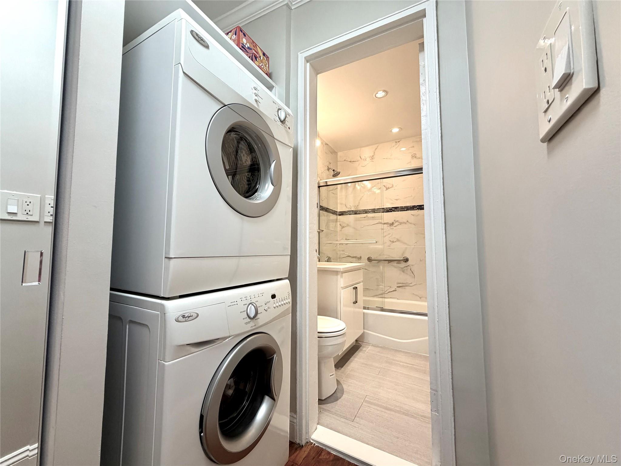 77-17 Springfield Boulevard, Unit 98 Queens, NY 11364 - Photo 2 of 18 a view of a bedroom with washer and dryer