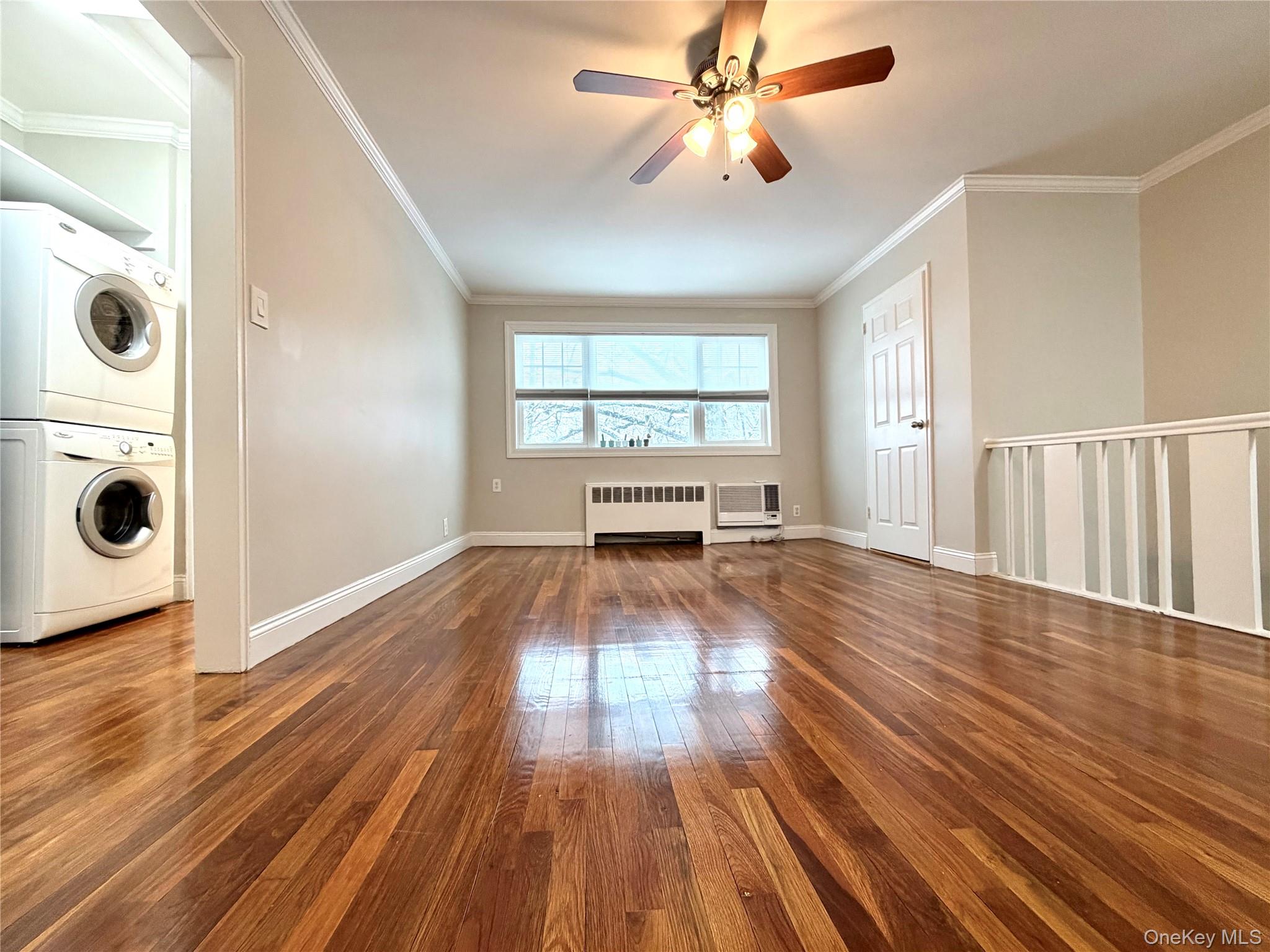 77-17 Springfield Boulevard, Unit 98 Queens, NY 11364 - Photo 7 of 18 wooden floor in an empty room with a window