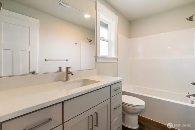 a bathroom with a sink a toilet and bathtub