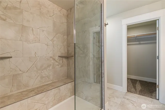 a bathroom with a glass shower door
