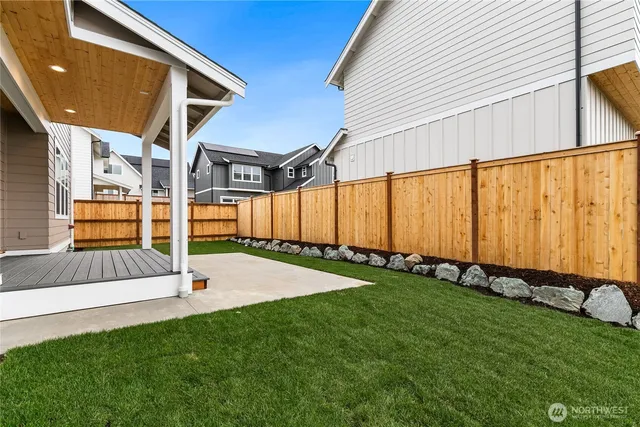 a view of an house with backyard and sitting area