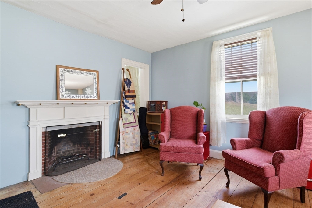 20 Depot Street Southwick, MA 01077 - Photo 14 of 36 a living room with furniture a flat screen tv and a fireplace