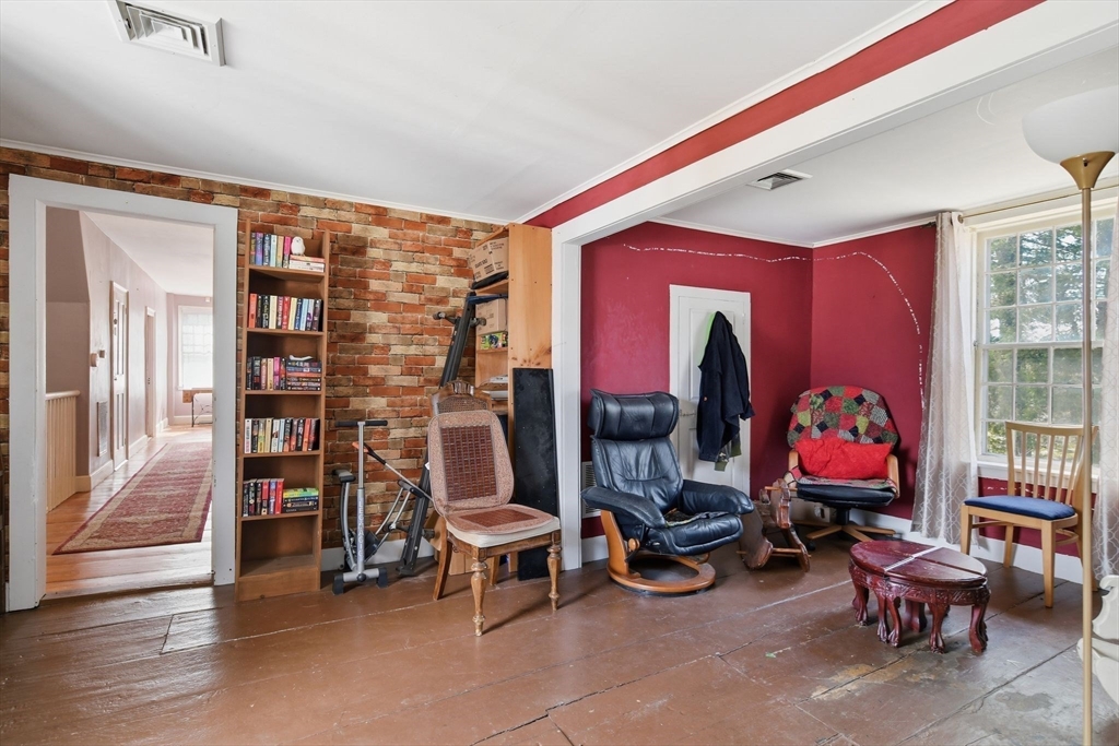 20 Depot Street Southwick, MA 01077 - Photo 26 of 36 a living room with furniture a rug and a bookshelf