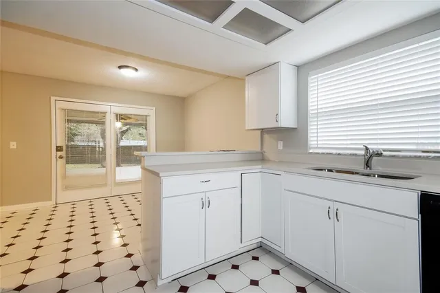 a kitchen with sink cabinets and window