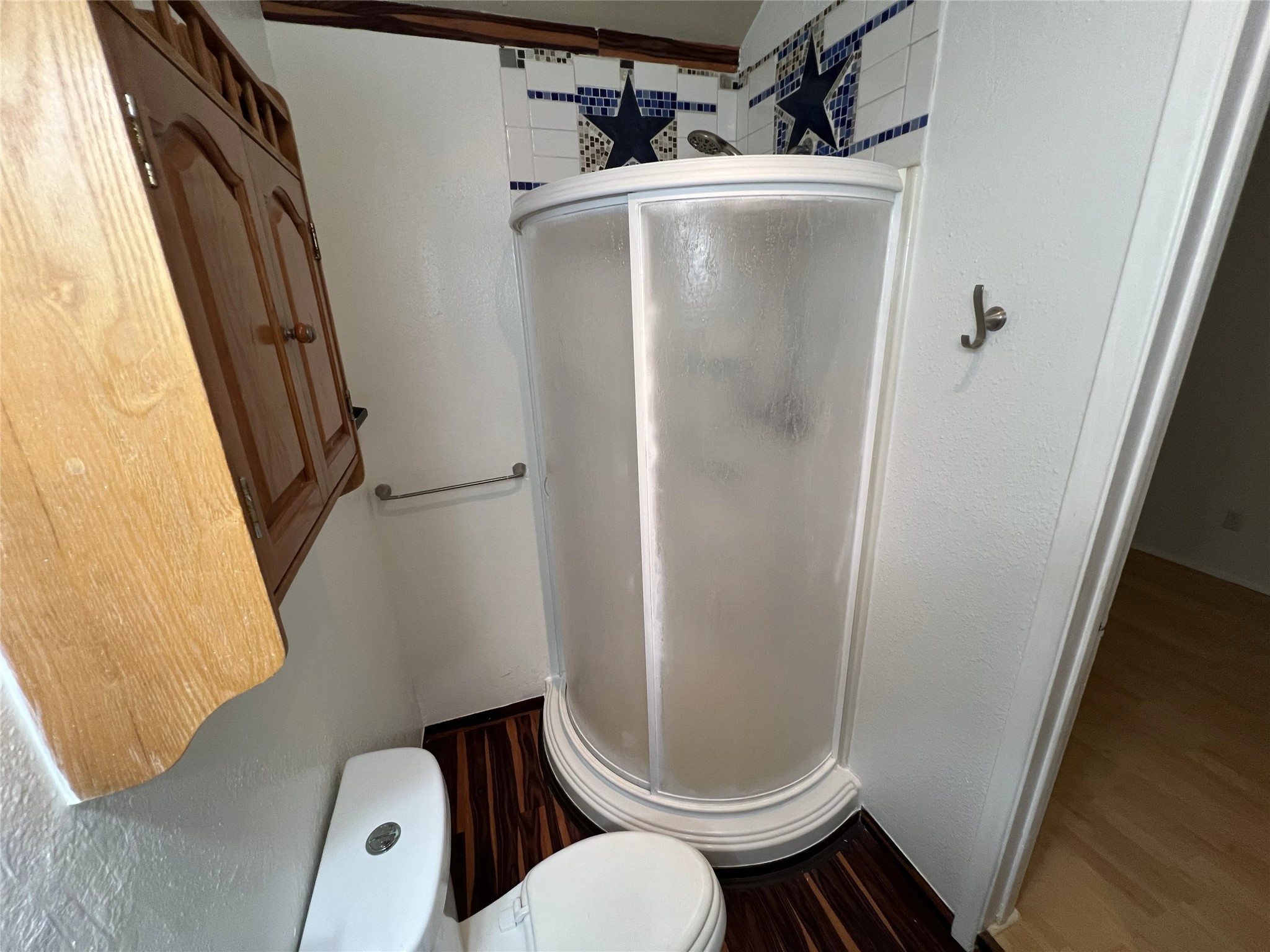 2500 Burleson Road, Unit 622 Austin, TX 78741 - Photo 15 of 17 Compact and practical, this bathroom features a streamlined shower stall and distinct wood flooring.