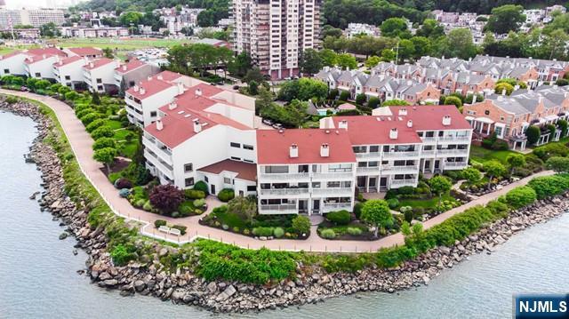an aerial view of residential houses with outdoor space and swimming pool