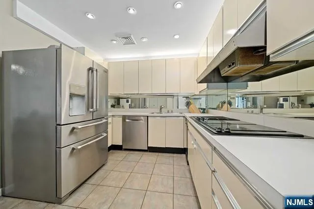 a kitchen with a sink a stove and refrigerator