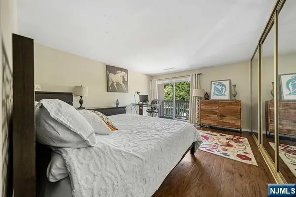 a bedroom with furniture and a wooden floor