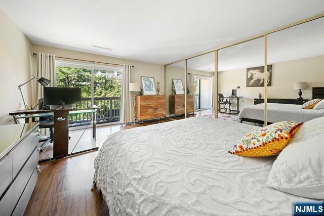 1225 River Road, Unit 6A Edgewater, NJ 07020 - Photo 17 of 30 a bedroom with furniture and a wooden floor