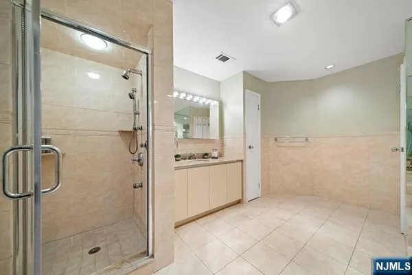 a bathroom with a granite countertop sink a toilet and shower