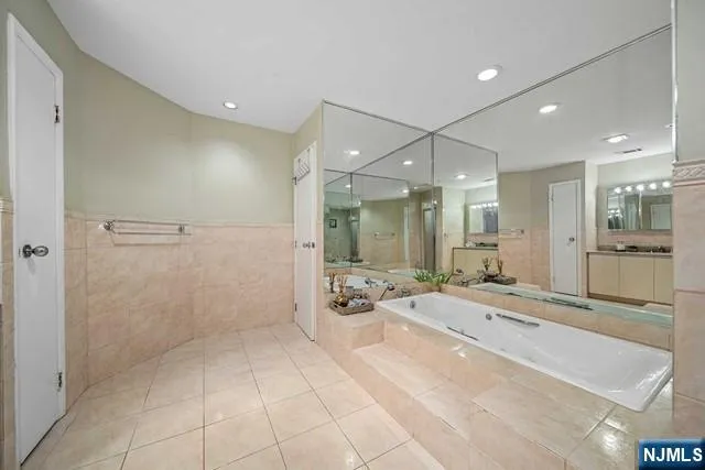 a bathroom with a granite countertop sink a toilet and shower