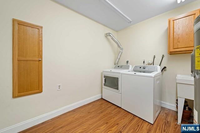1225 River Road, Unit 6A Edgewater, NJ 07020 - Photo 27 of 30 a utility room with wooden floor washer and dryer