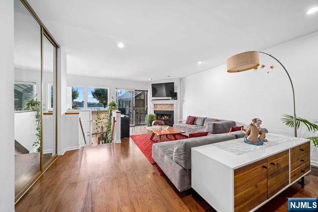 1225 River Road, Unit 6A Edgewater, NJ 07020 - Photo 8 of 30 a living room with fireplace furniture and a large window