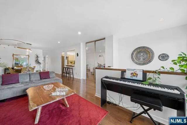 a living room with furniture and wooden floor
