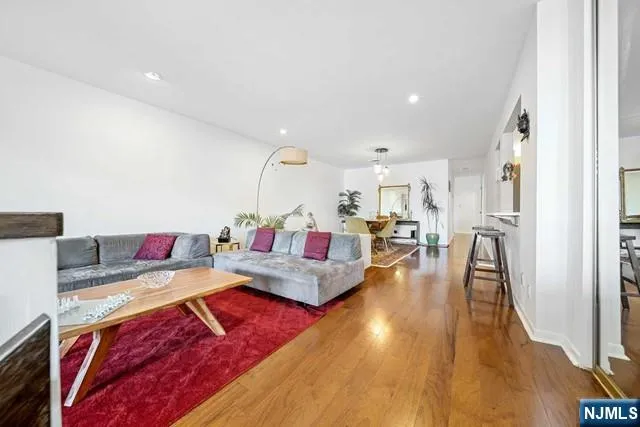 a living room with furniture and a wooden floor