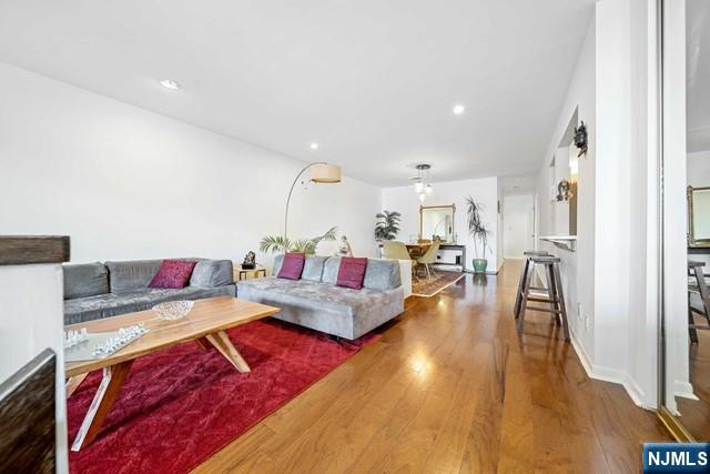 1225 River Road, Unit 6A Edgewater, NJ 07020 - Photo 10 of 30 a living room with furniture and a wooden floor