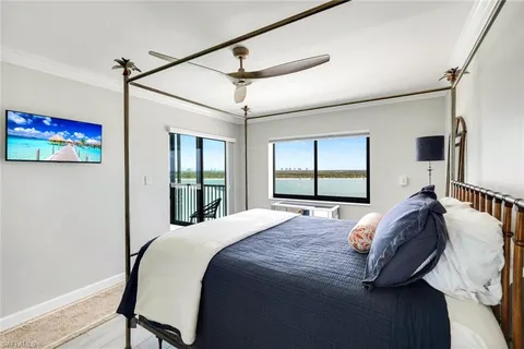 a bedroom with a large bed and a window