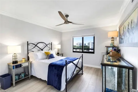 a bedroom with a bed and a tv on the dresser
