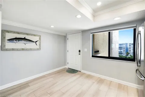 a view of a room with wooden floor and cabinet