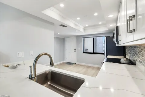 a kitchen with sink and refrigerator