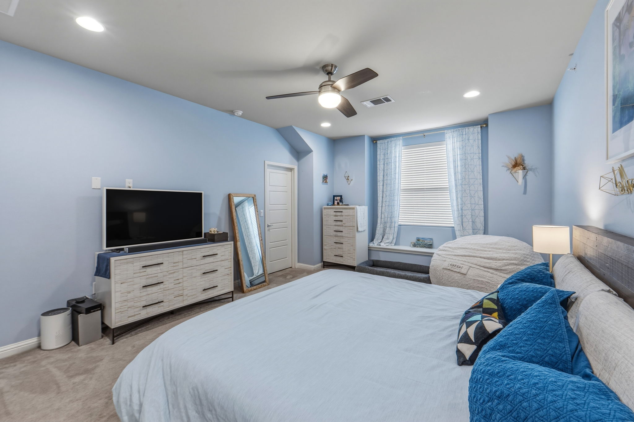 6814 East Riverside Drive, Unit 34 Austin, TX 78741 - Photo 15 of 26 a bedroom with a bed and a flat screen tv