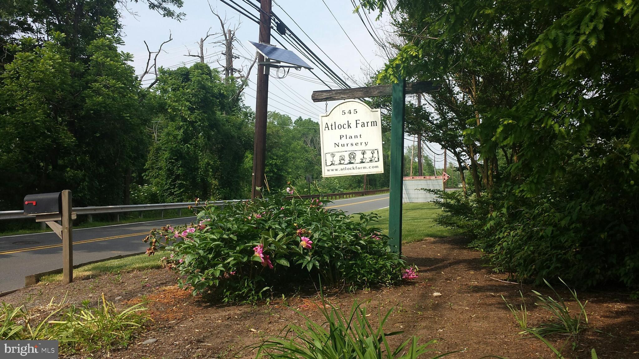 545 Weston Canal Road Somerset, NJ 08873 - Photo 2 of 41 a sign that is in front of flowers