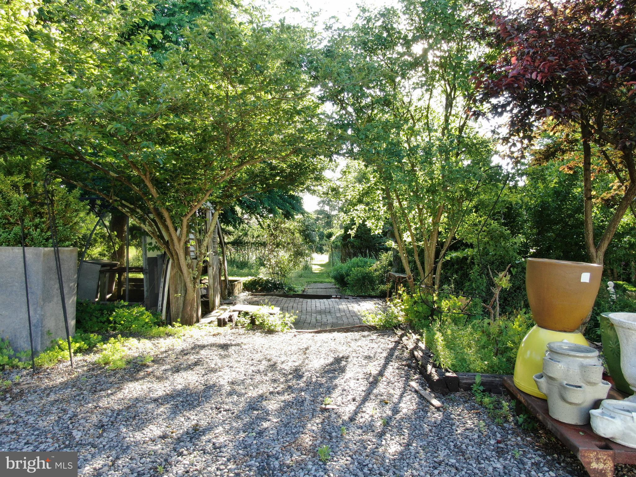 545 Weston Canal Road Somerset, NJ 08873 - Photo 26 of 41 a view of a backyard with table and chairs and potted plants