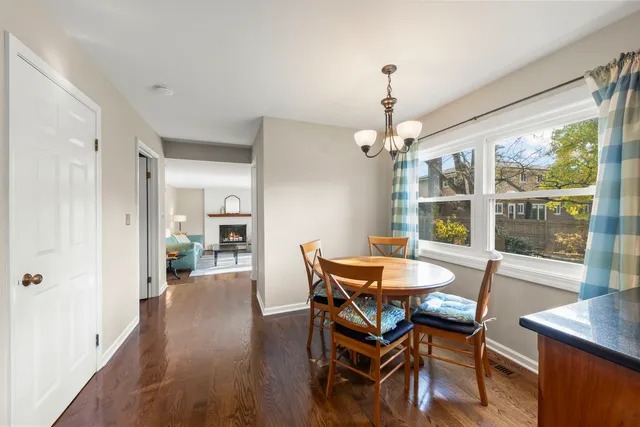 a dining room with furniture window and wooden floor