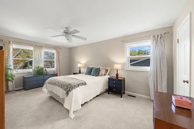 a spacious bedroom with a bed and a couch