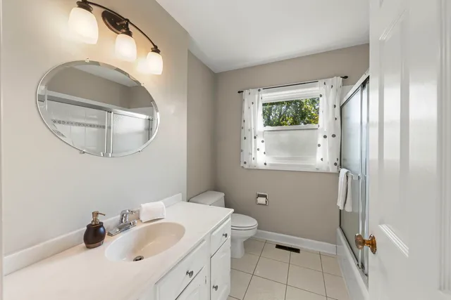a bathroom with a sink toilet and a mirror