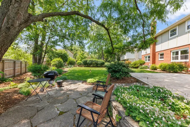 a view of a patio with table and chairs under an umbrella