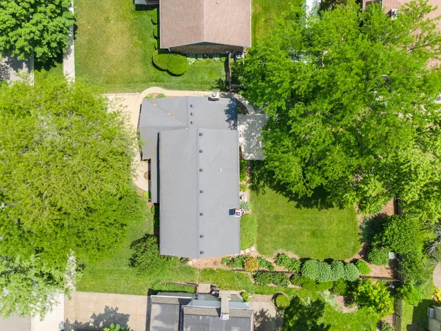 an aerial view of a house with a yard